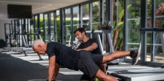 Overcoming Fitness Plateaus: Tips and Tricks from Personal Trainers Personal trainer helping an old man in the gym