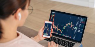 Mastering Forex Markets: A Strategic Guide to Trading with CFDs woman looking at financial stock market using cellphone and laptop