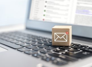 Trustworthy Transactions: The Power of Reliable Check Mailing in Brand Building email symbol on wooden block