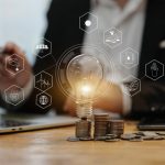 light bulb with stack of coins