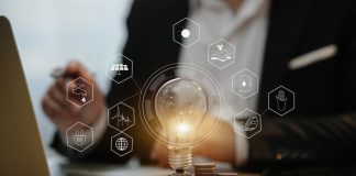 BlueHoldings Launches Exciting Bonus For Capitalists light bulb with stack of coins