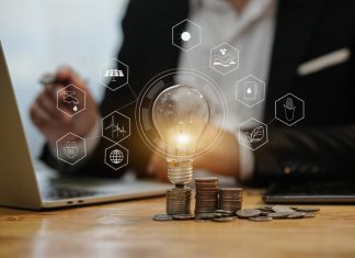 light bulb with stack of coins