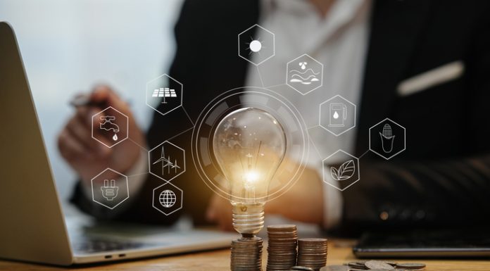 BlueHoldings Launches Exciting Bonus For Capitalists light bulb with stack of coins