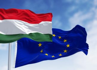 Beyond Latest EU-Hungary Tussle Is a Deteriorating Rule-Of-Law Picture Across Europe Flags of Hungary and the European Union fluttering together on a clear day