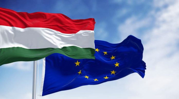 Beyond Latest EU-Hungary Tussle Is a Deteriorating Rule-Of-Law Picture Across Europe Flags of Hungary and the European Union fluttering together on a clear day