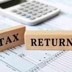 Tax return text on wooden block