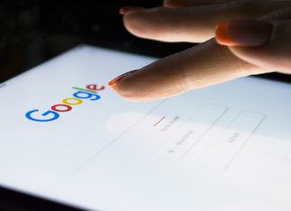 Google Consent Mode V2: Advertisers Face Deadline in March 2024 A woman's hand is touching screen on tablet computer iPad Pro at night for searching on Google search engine. Google is the most popular Internet search engine in the world.
