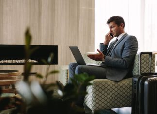 Tips and Resources for Staying Connected While on Business Trips business man talking to someone on the phone