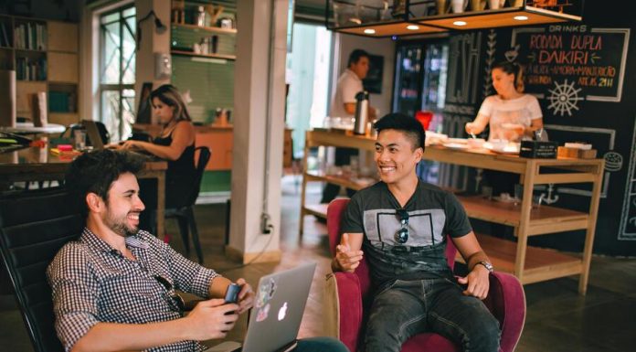 Gentlemen having a conversation while sitting on chairs