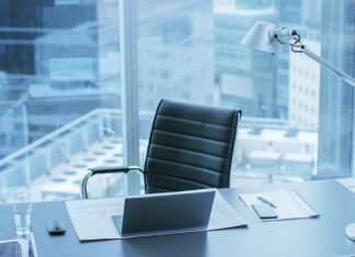 High Angle Shot of a Working Desk of an Successful Person in Office with Cityscape Window View.