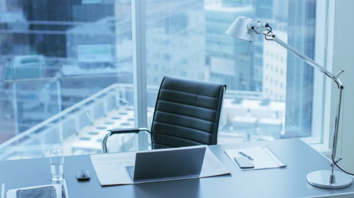High Angle Shot of a Working Desk of an Successful Person in Office with Cityscape Window View. High Angle Shot of a Working Desk of an Successful Person in Office with Cityscape Window View.