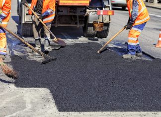 The workers are asphalt paving the roads.