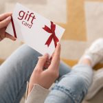 woman holding a gift card