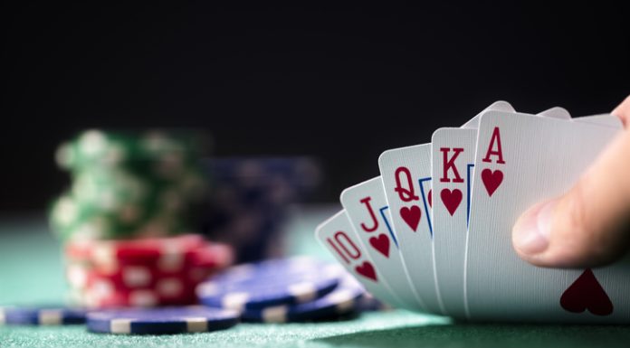 From Riverboats to Livestreams: Online Poker’s Wild Ride Playing poker in a casino holding winning royal flush hand of cards