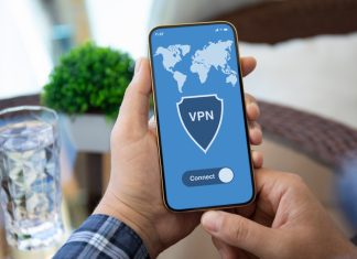 Male holding phone with VPN on screen