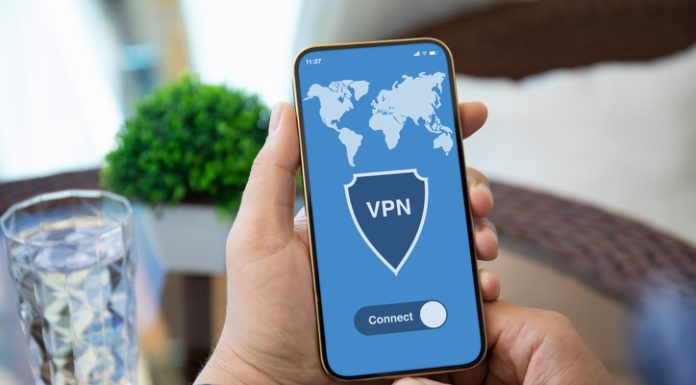 Streamlined VPN Connection: Quick Connect Male holding phone with VPN on screen