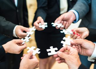 People assembling a jigsaw puzzle