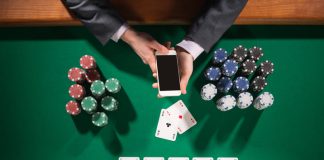 What to Look for in Casino Sites in Bangladesh Man playing poker while holding smart phone