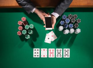 Man playing poker while holding smart phone
