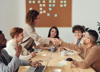 Enhancing Negotiation and Conflict Resolution with Emotional Intelligence Colleagues Shaking each other's Hands. How a leader shows Emotional Intelligence towards colleague