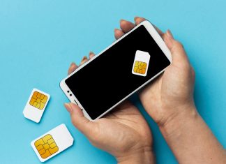 Front view of hands holding smartphone sim cards