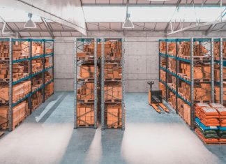 Interior of a warehouse with shelves and pallets full of different package