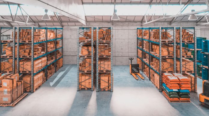 The Evolving Landscape of Warehouse Management Systems in Europe Interior of a warehouse with shelves and pallets full of different package