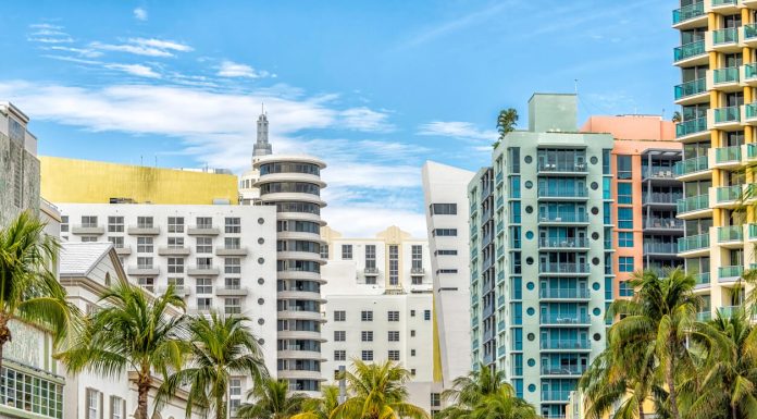 What are the Safest Neighborhoods in Miami Miami South Beach Ocean Drive road street with famous retro art deco hotel colorful buildings cityscape with palm trees and blue sky on sunny day