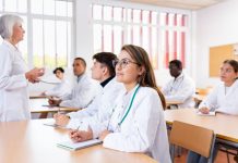 medical students sitting at desk in classroom during lecture