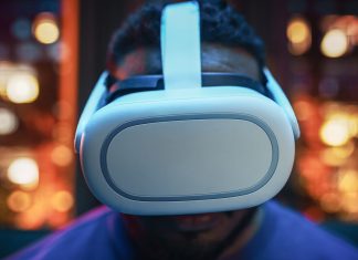 Cinematic Portrait of a Young Stylish Black Man Using Virtual Reality Headset with Joysticks