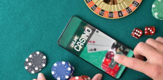 Online game app on tablet on game table with objects