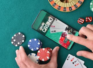 Online game app on tablet on game table with objects