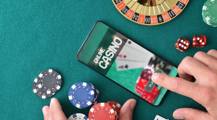 Online game app on tablet on game table with objects