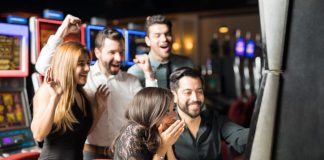 Group of people looking excited about hitting the jackpot in a slot machine