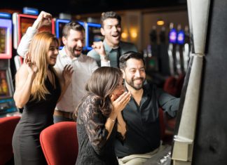 Group of people looking excited about hitting the jackpot in a slot machine
