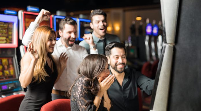 Is It Really Worth Utilizing Bonus Buy at International Online Casinos? Group of people looking excited about hitting the jackpot in a slot machine