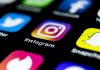 Top 8 Tools for Instagram Marketing: Beginners and Professionals Apple iPhone X on office desk with icons of social media network instagram application on screen. Social network. Starting social media app.