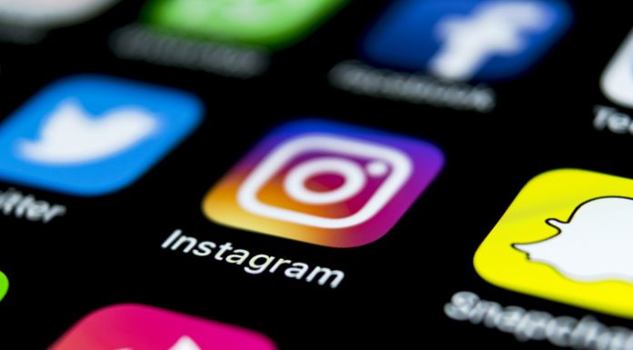 Top 8 Tools for Instagram Marketing: Beginners and Professionals Apple iPhone X on office desk with icons of social media network instagram application on screen. Social network. Starting social media app.
