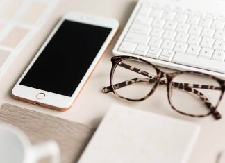 gold iPhone 7 beside black and brown framed eyeglasses