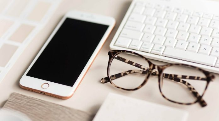 gold iPhone 7 beside black and brown framed eyeglasses
