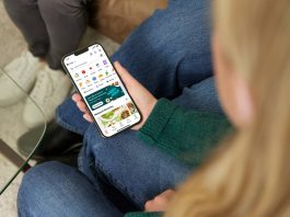 a woman sitting on a couch holding a cell phone