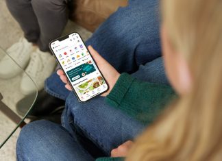 a woman sitting on a couch holding a cell phone