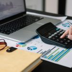 Business woman calculator and laptop for calculating finance, tax, accounting, statistics and analytic research concept