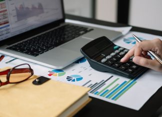 Business woman calculator and laptop for calculating finance, tax, accounting, statistics and analytic research concept