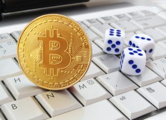 Bitcoin and casino dice on keyboard