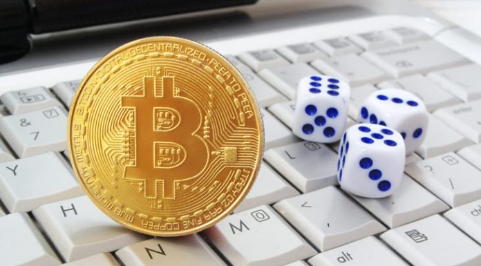 Bitcoin and casino dice on keyboard