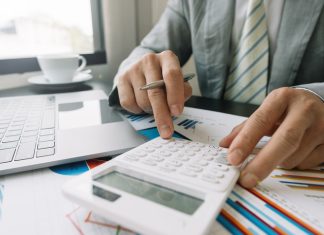 Businessman using calculator for finance accounting