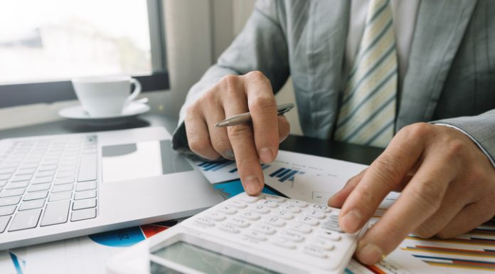 Businessman using calculator for finance accounting