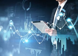 Businessman holding tablet for stocks