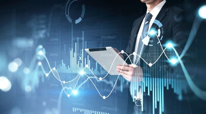 Businessman holding tablet for stocks